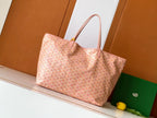 Pink patterned tote bag with leather handles and structured base