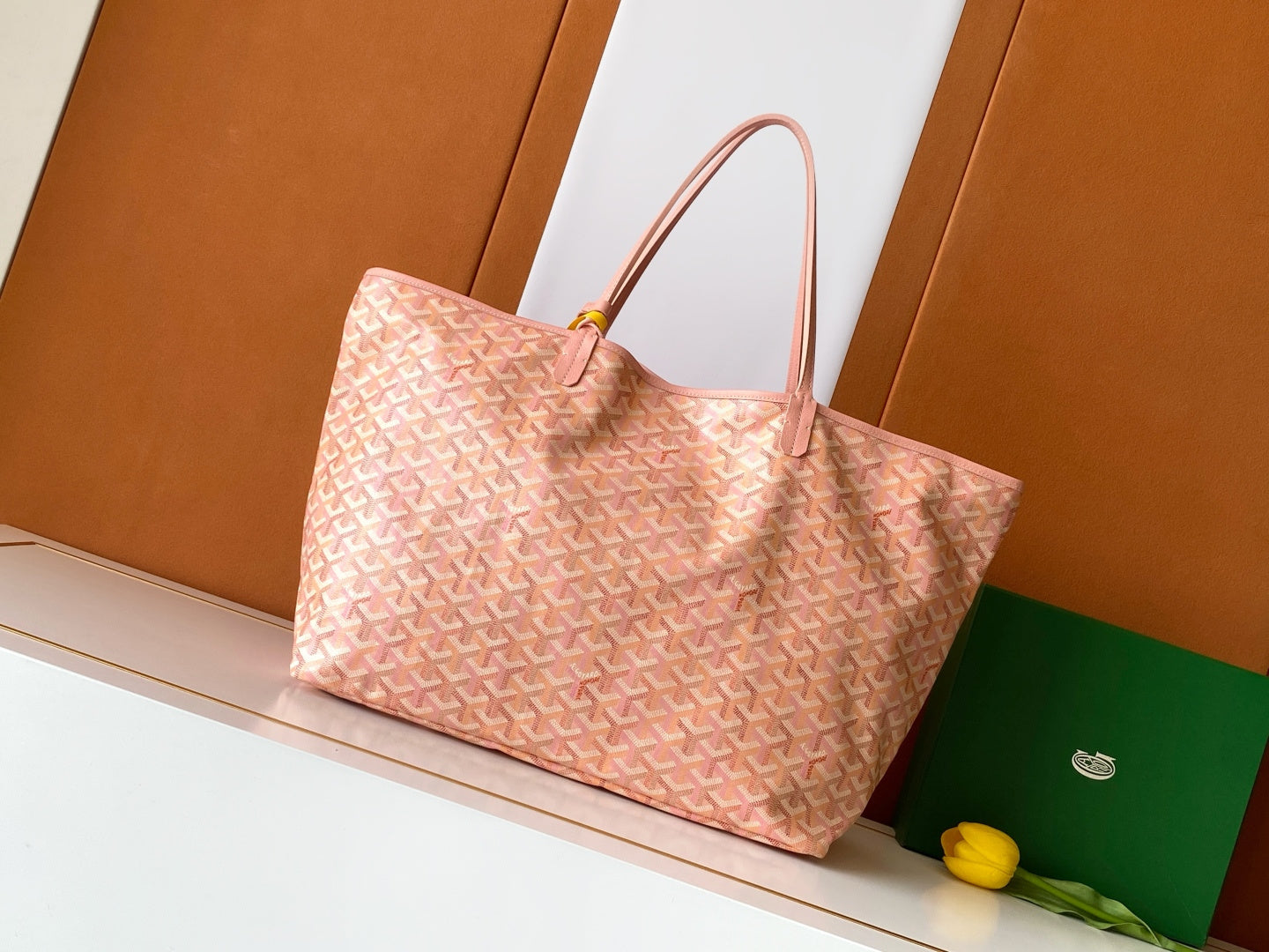 Pink patterned tote bag with leather handles and structured base
