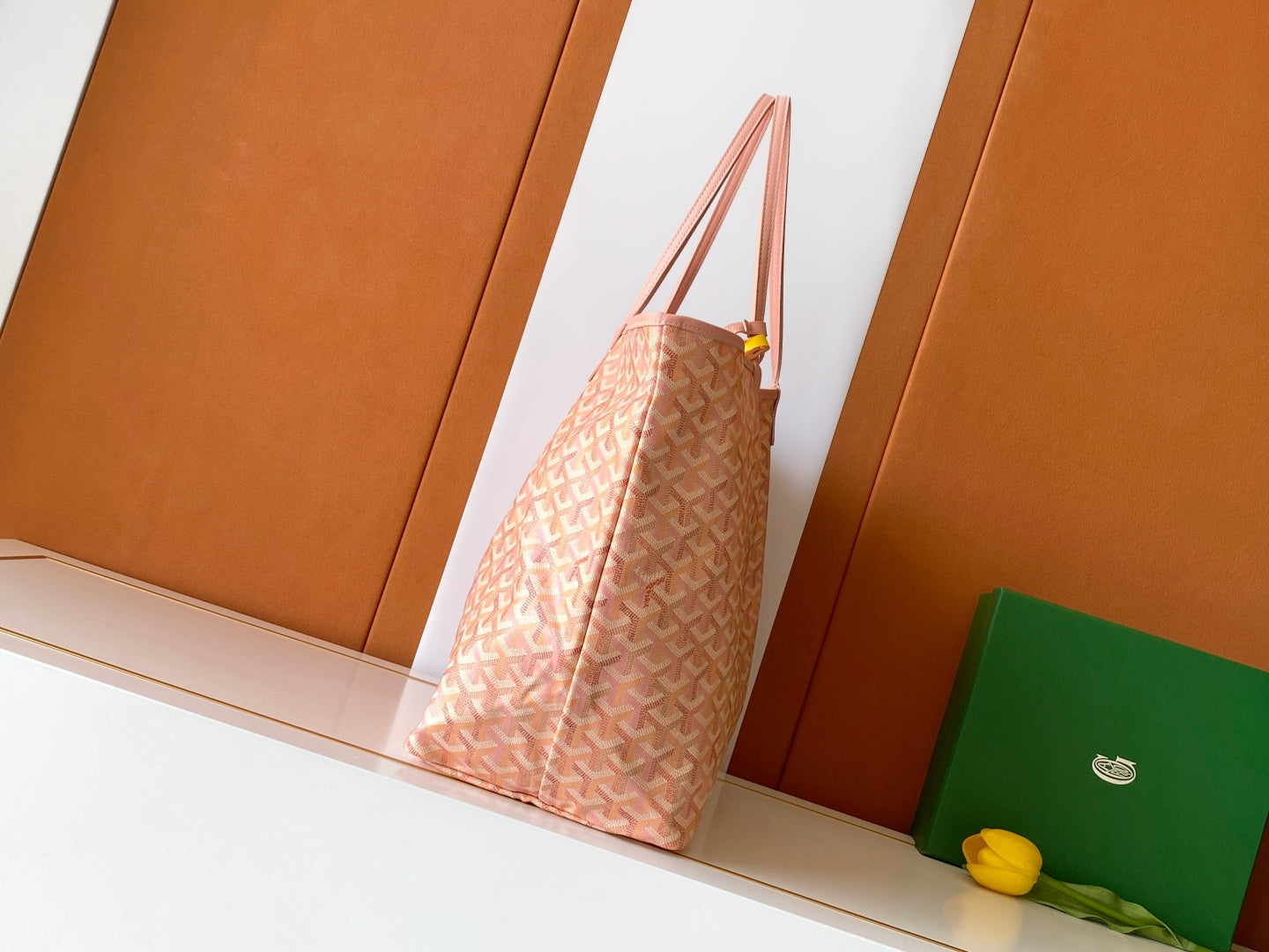 Pink patterned tote bag with long handles, shown from the side