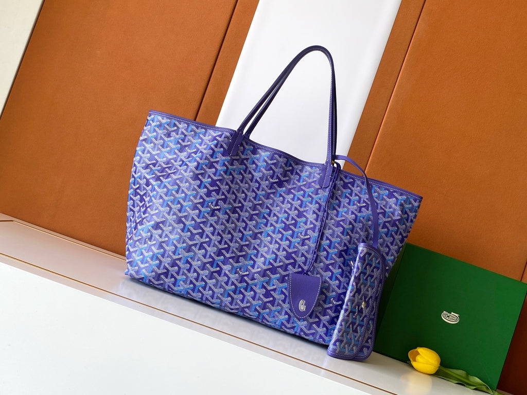 Purple monogram tote bag with top handles and round front emblem