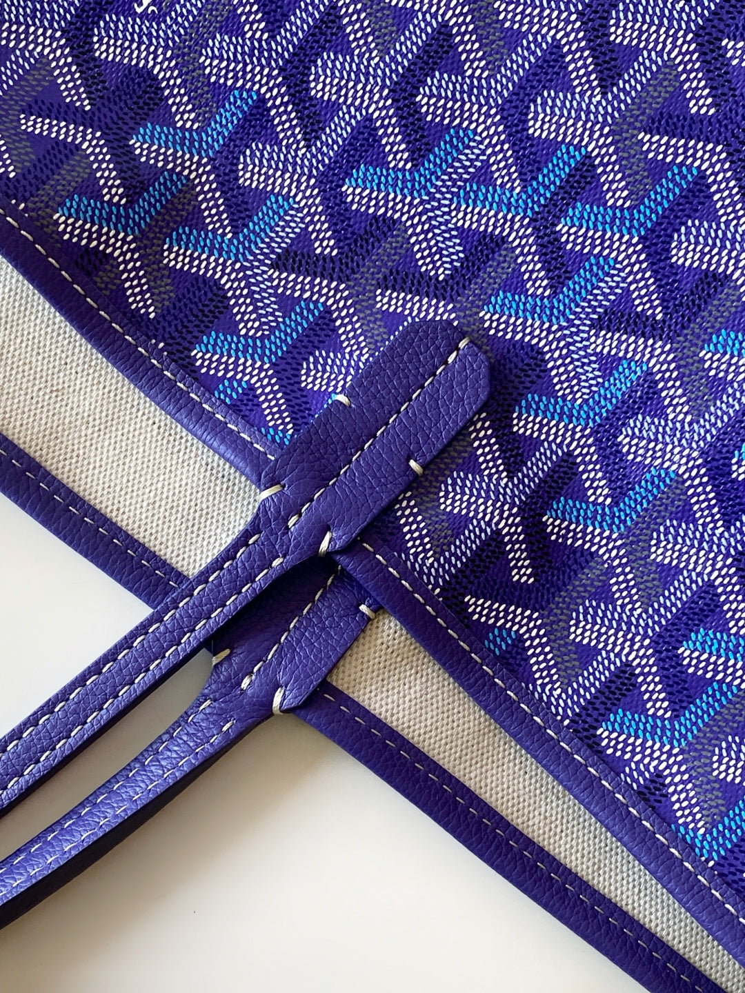 Purple monogram tote bag with cross-stitched handle attachment and piping
