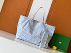 Light blue and white patterned tote bag with leather trim and dual top handles