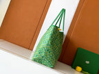 Goyard green patterned tote bag with looping top handles and hanging strap