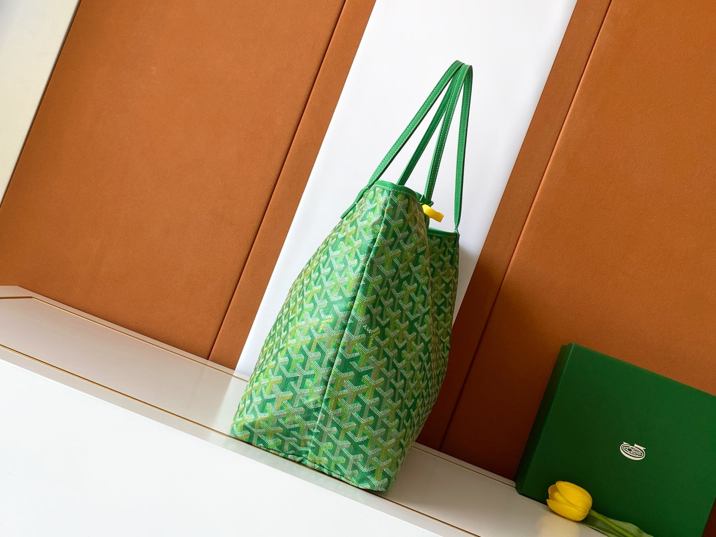 Goyard green patterned tote bag with looping top handles and hanging strap