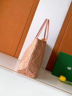 Tote bag in pink patterned canvas with leather top handles and side profile
