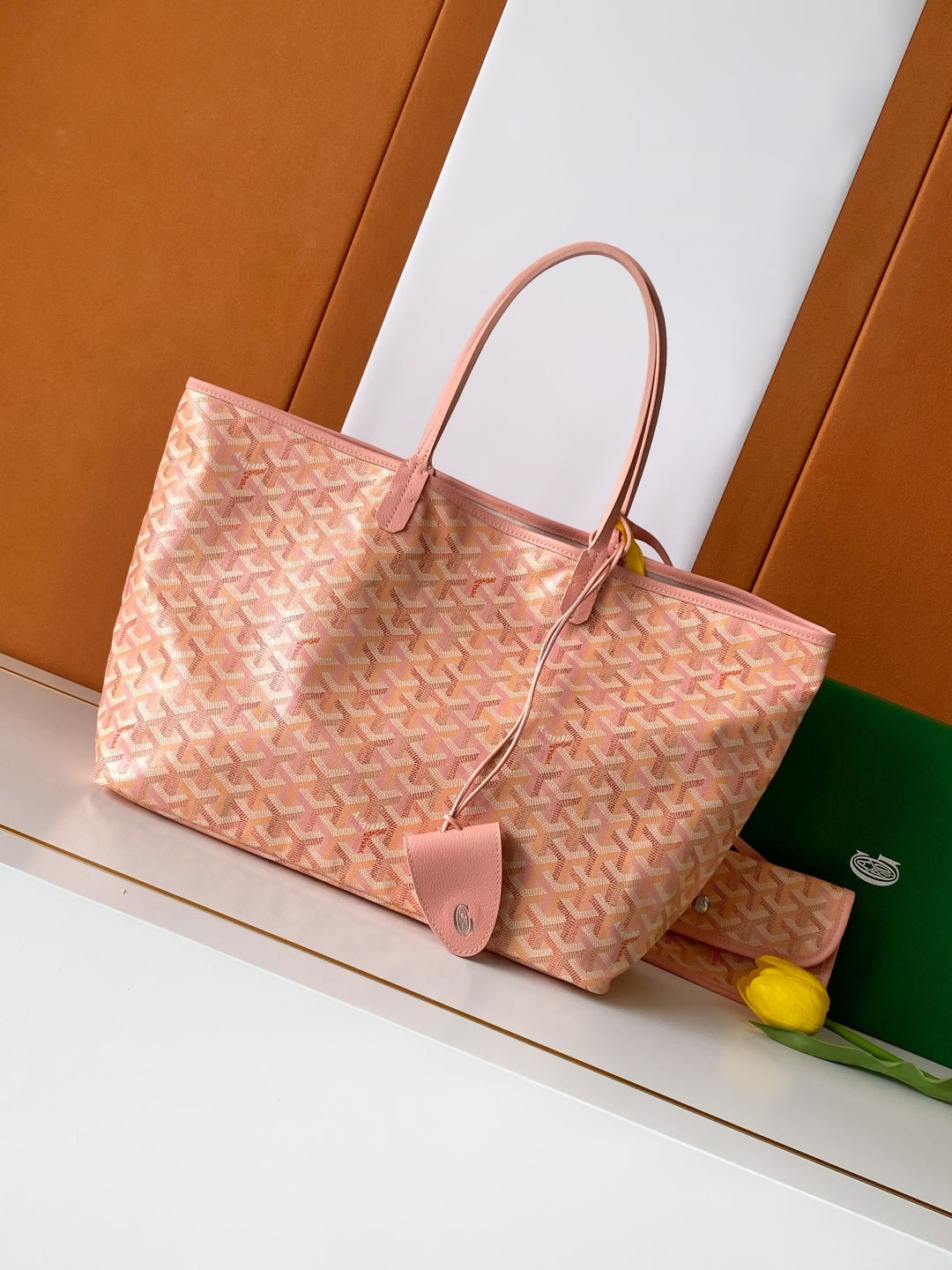 Tote bag in pink patterned canvas with leather handles and hanging leather tag