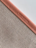Tote bag strap in textured gray with pink leather edging and embossed branding