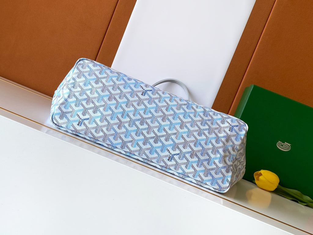 Light blue patterned tote bag lying down with top handles