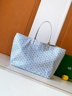 Light blue patterned tote bag with silver-tone hardware and top handles