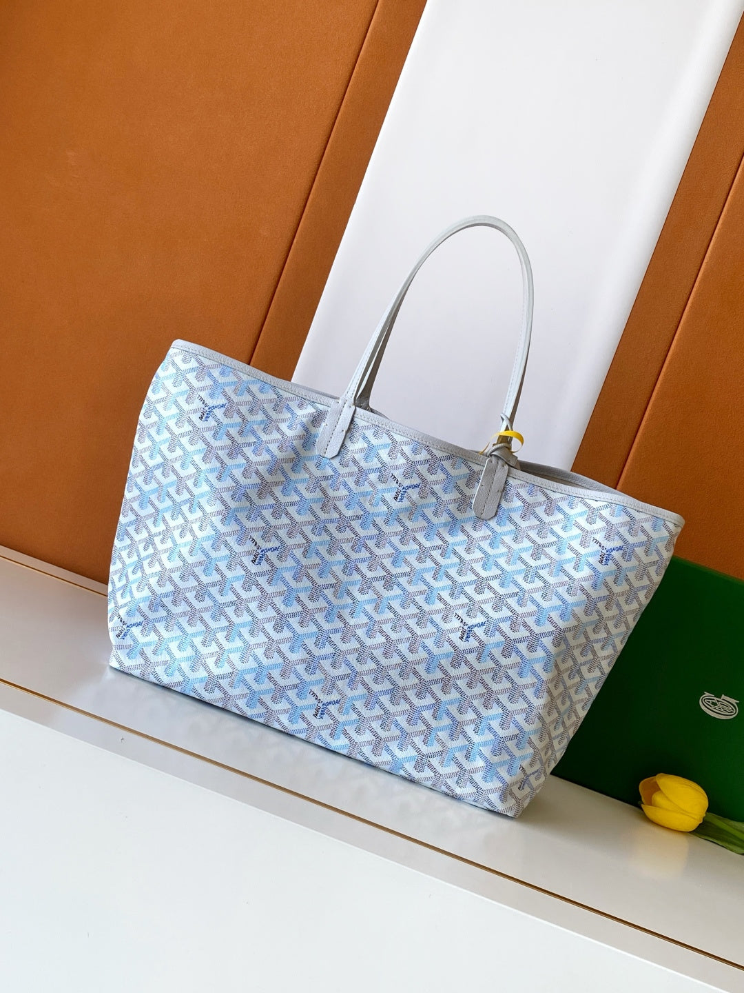 Light blue patterned tote bag with silver-tone hardware and top handles