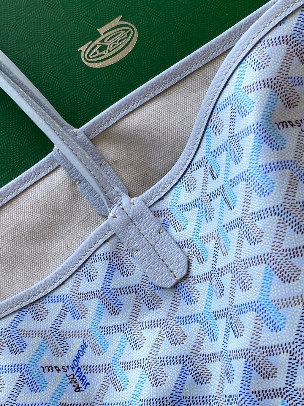 Light blue patterned tote interior with fabric lining and stitched pocket