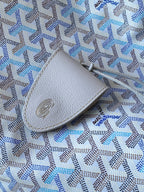 Light blue patterned pouch with light gray leather patch and stitched edge
