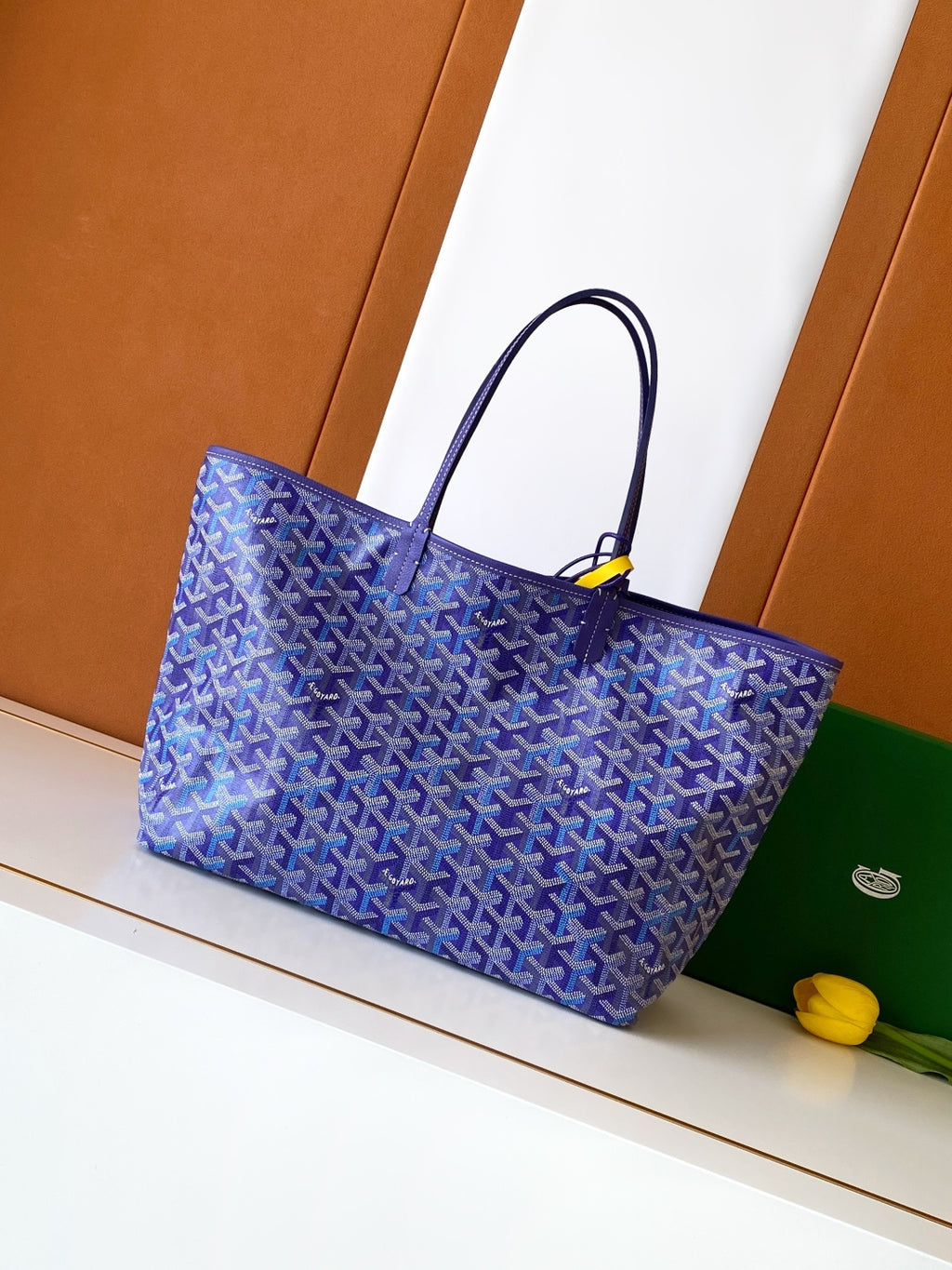 Blue patterned tote bag with top handles, front angle view