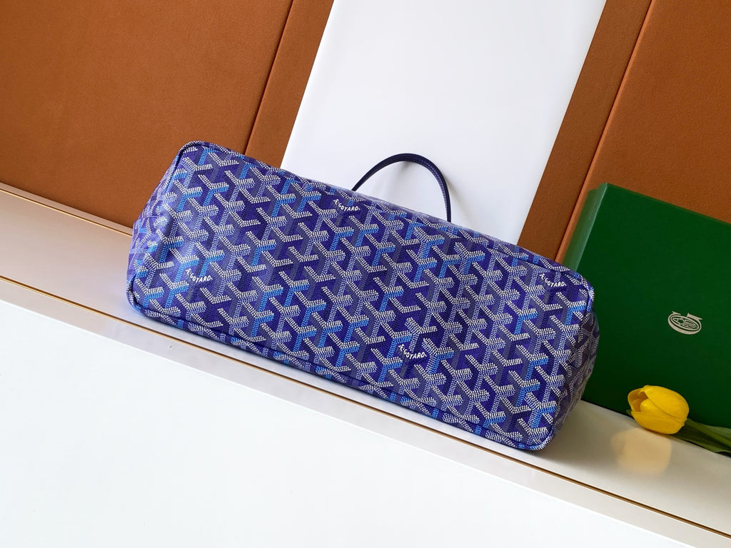 Blue patterned tote bag with wide base and top handles, angled profile