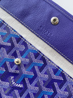 Blue patterned tote bag panel with purple leather accents and metal snap studs