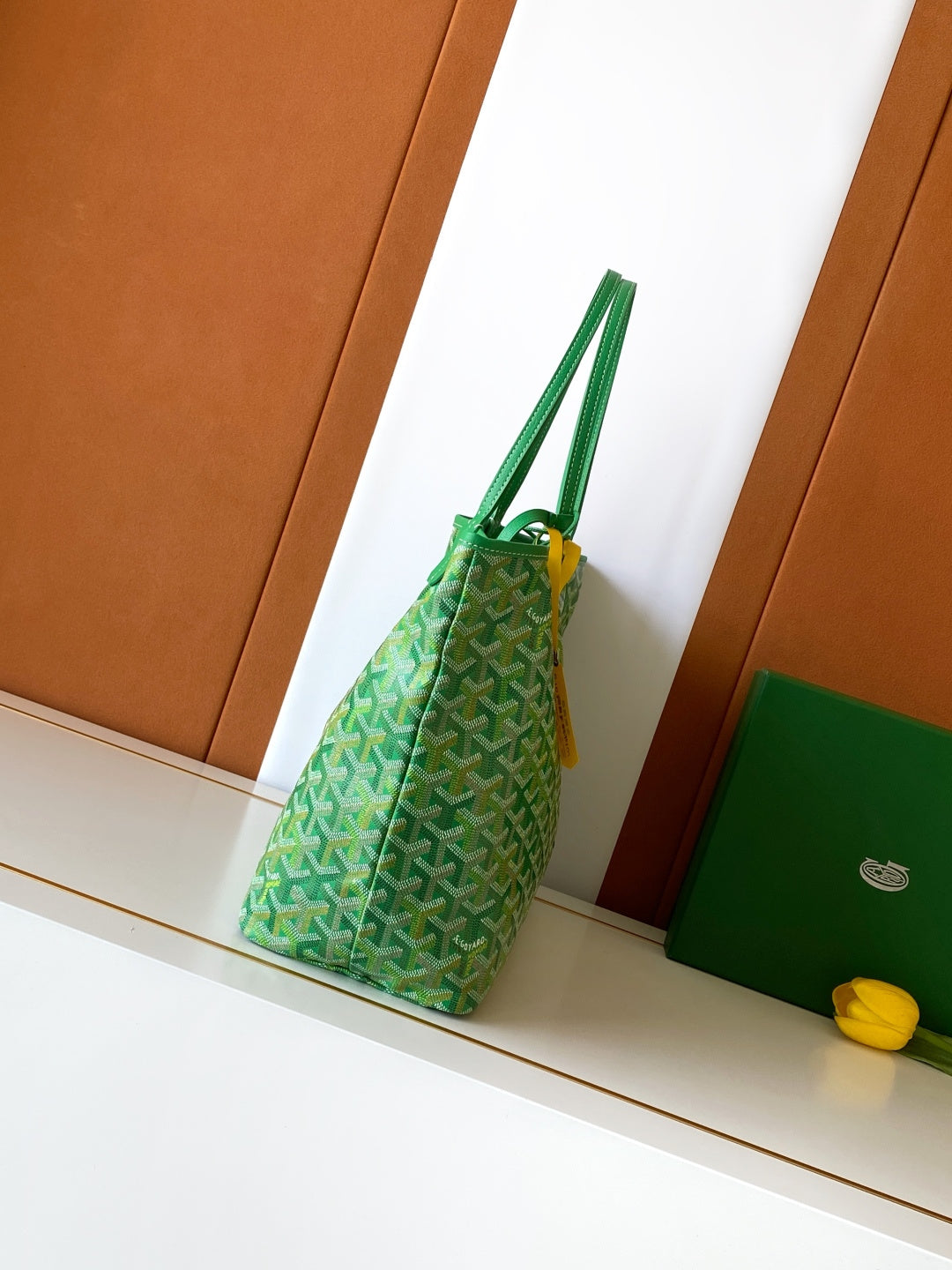 Green patterned tote bag shown from the side with double top handles