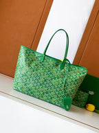 Green patterned tote bag with top handles and attached green strap charm