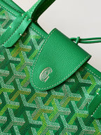 Green patterned tote bag close-up of leather tab with snap and stitch detail
