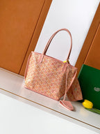 Pink patterned tote bag with two top handles and a small bow detail.
