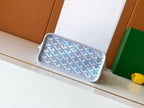 Light blue monogram clutch-style pouch with zip top and wrist strap