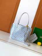 Light blue patterned tote bag with top handles and leather trim