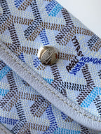Light blue monogram tote bag top closure with round metal logo button