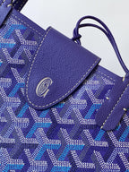 Goyard tote bag close-up, blue patterned flap with leather trim and stitched edge