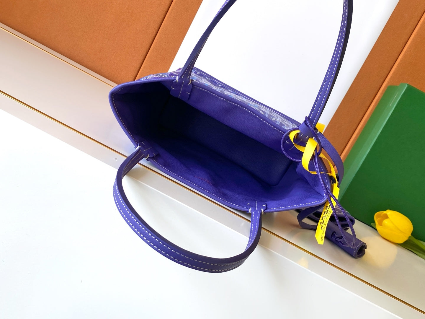 Goyard tote bag interior view, blue patterned lining with top opening and handles