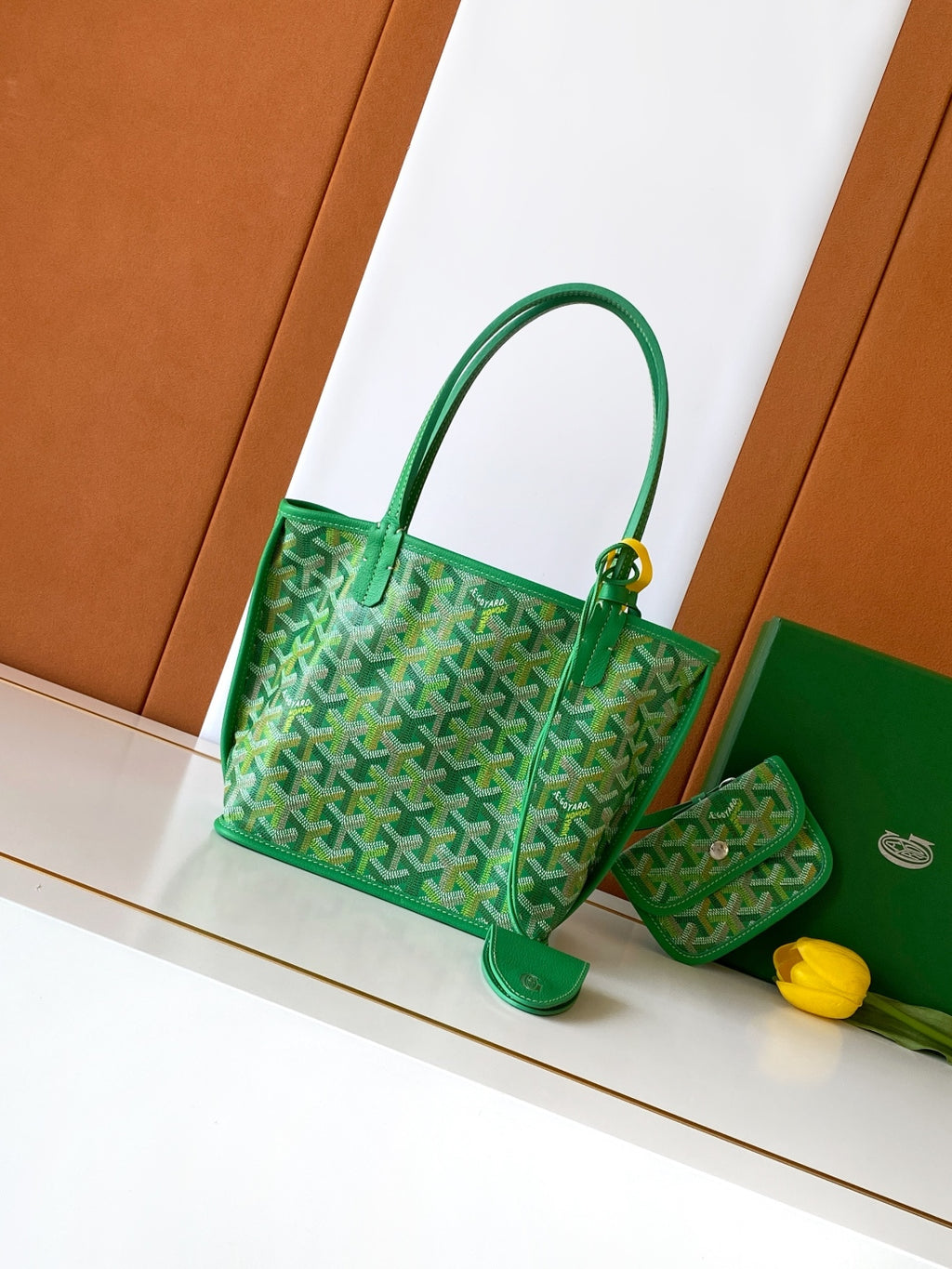 Green patterned tote bag with top handles and gold-tone clasp