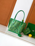 Green patterned tote bag with top handles and gold-tone clasp