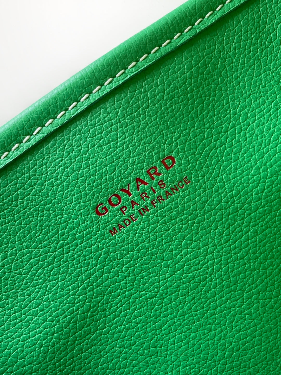 Green leather tote bag with embossed Goyard logo and stitched edge