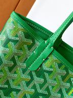 Green patterned tote bag corner with stitched trim and green strap