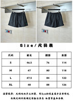 Balenciaga plaid shorts shown from front, elastic waistband and dark grid pattern
