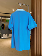 Blue Burberry polo shirt, back view on hanger with short sleeves