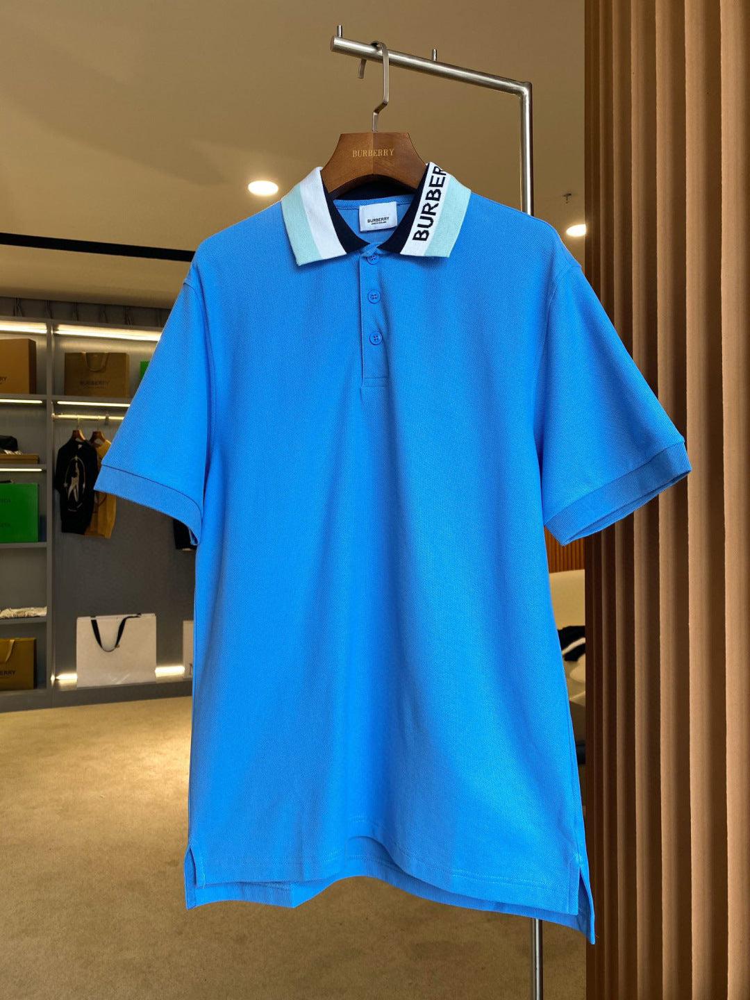 Blue Burberry polo shirt on hanger, short sleeves, button placket