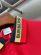 Red polo shirt close-up of striped collar with Burberry label and buttons