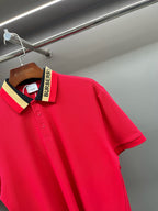 Red polo shirt close-up of the shoulder and collar with logo tag