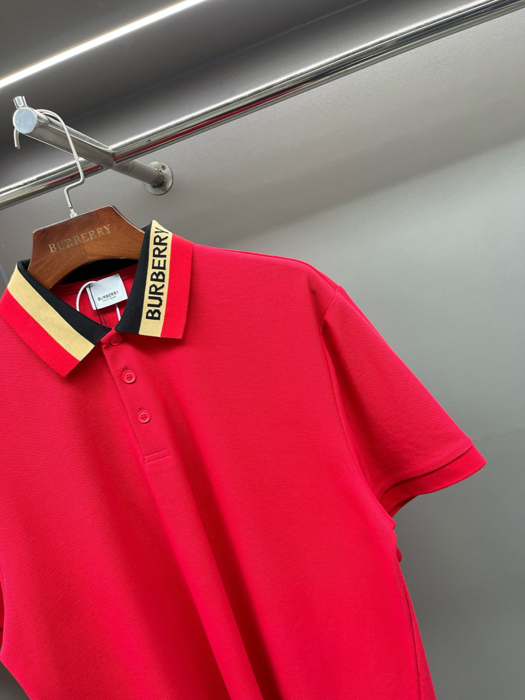 Red polo shirt close-up of the shoulder and collar with logo tag