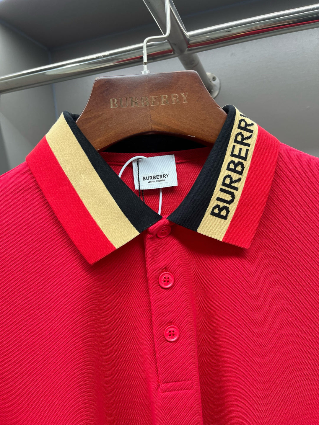 Red polo shirt with striped collar and Burberry-branded button placket