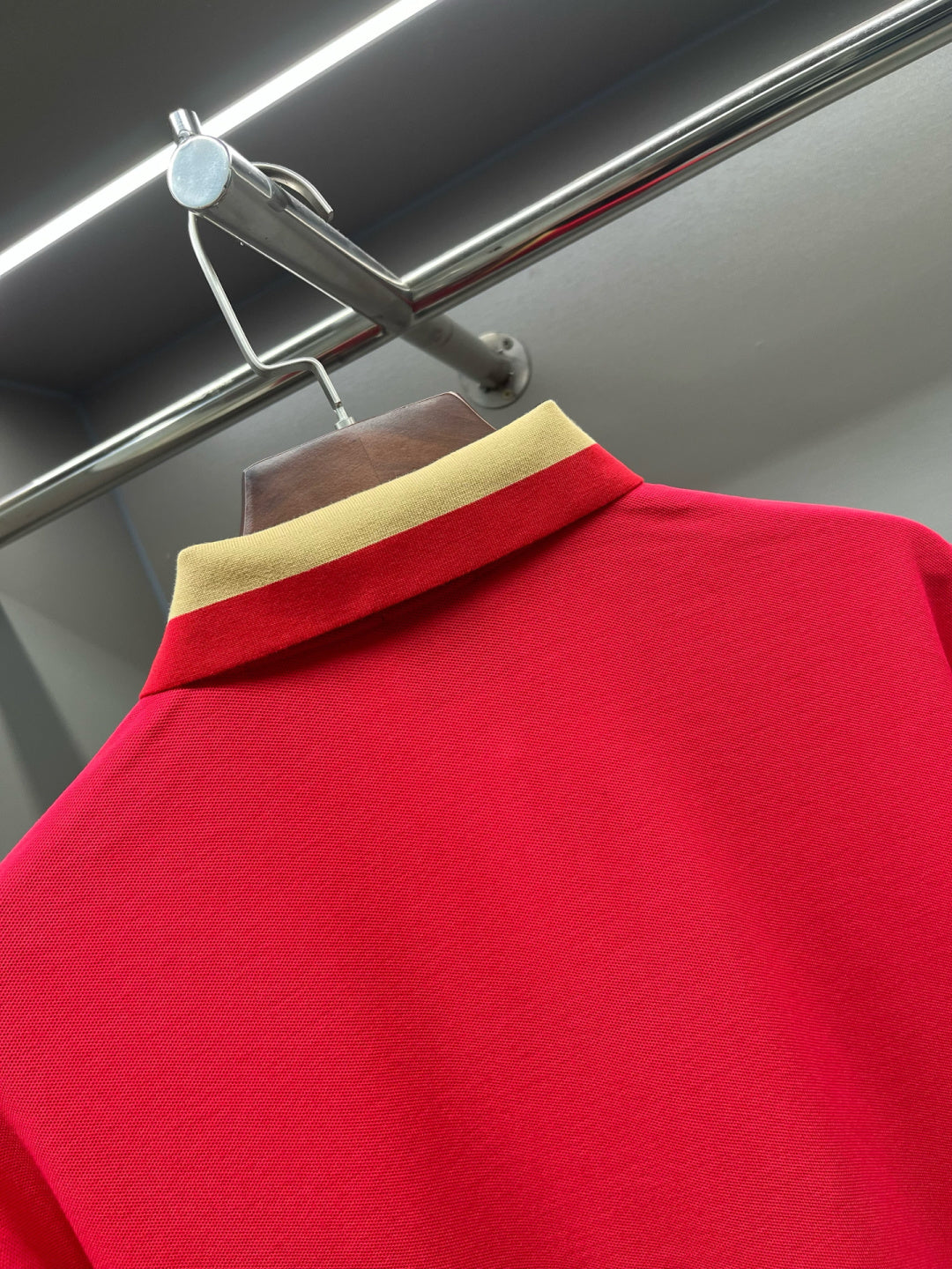 Red polo shirt close-up of striped collar with Burberry logo on neck label