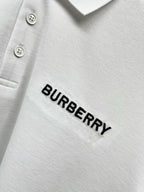 Close-up of Burberry wordmark on white polo shirt fabric