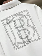 Close-up of white Burberry polo shirt back monogram graphic in outlined lines