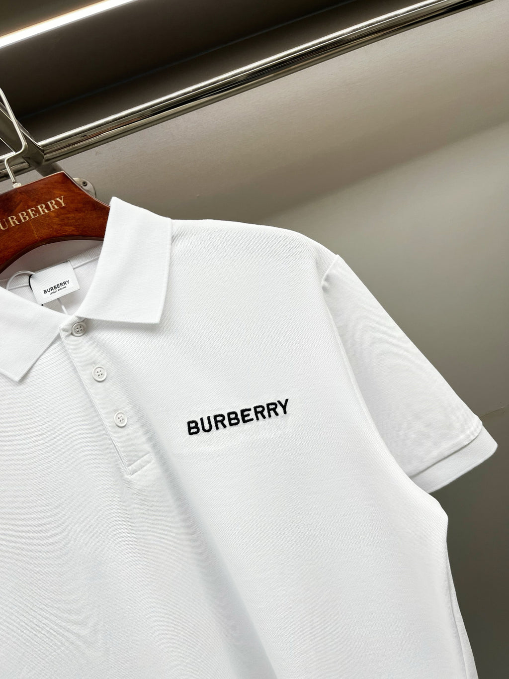 White Burberry polo shirt back corner view with small logo on chest