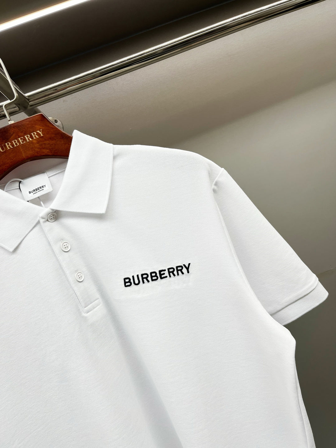 White Burberry polo shirt back corner view with small logo on chest