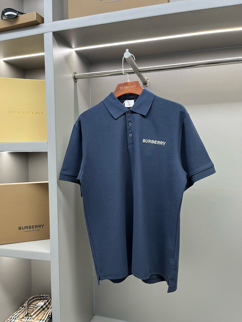 Blue polo shirt with collar and button placket, Burberry logo on chest