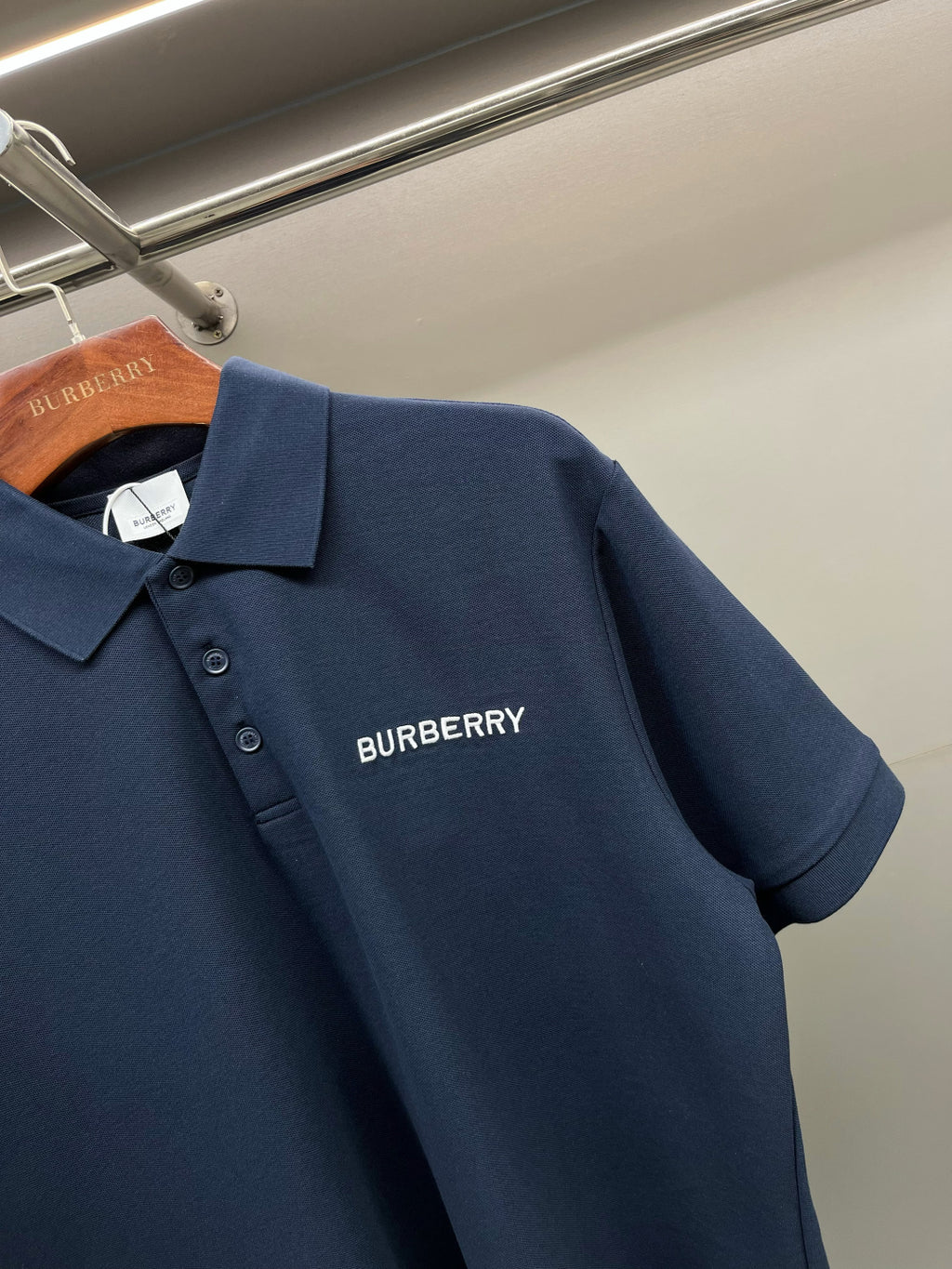Blue polo shirt with Burberry logo on chest and short sleeves