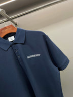 Blue polo shirt with Burberry logo on chest and short sleeves