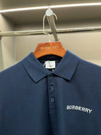 Blue polo shirt with spread collar, button placket, Burberry logo detail