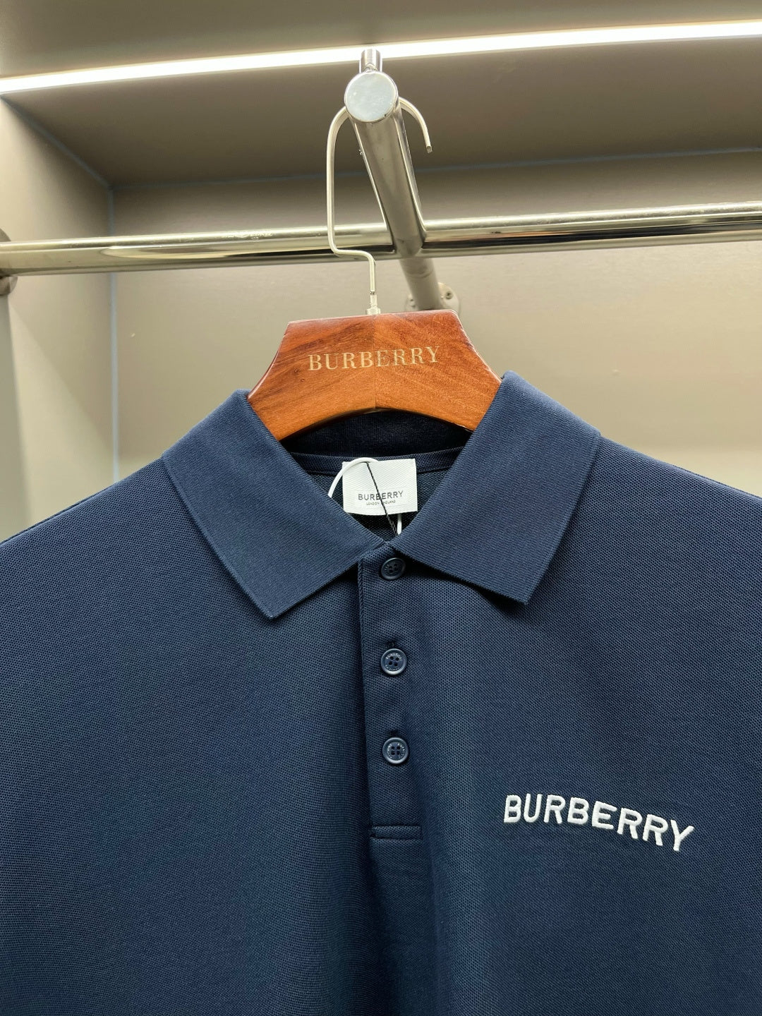 Blue polo shirt with spread collar, button placket, Burberry logo detail