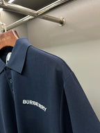 Blue polo shirt back with Burberry logo text near center